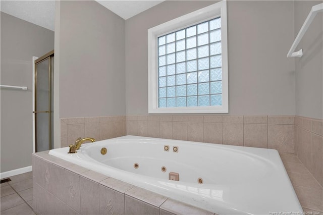 4010 Arcadia Ct, Fayetteville, NC 28311 - bathroom featuring a shower stall, a jetted tub, and tile patterned floors