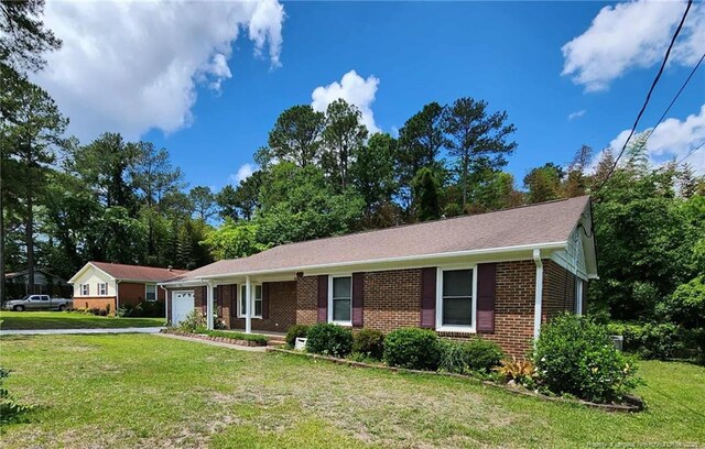 1519 Palmer Dr, Fayetteville, NC 28303 - single story home featuring an attached garage, brick siding, a front yard, and driveway