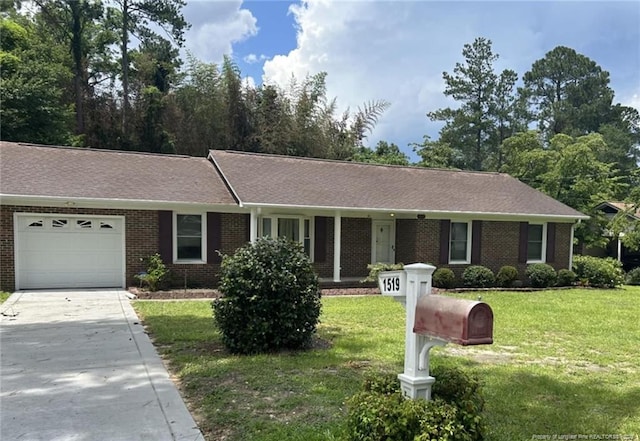 1519 Palmer Dr, Fayetteville, NC 28303 - ranch-style house featuring a garage, driveway, brick siding, and a front yard