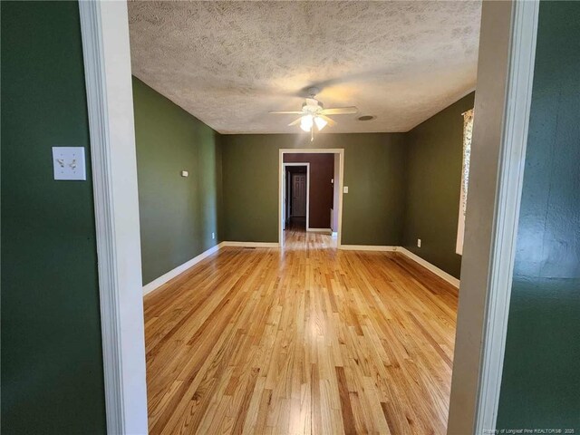 1519 Palmer Dr, Fayetteville, NC 28303 - unfurnished room featuring light wood finished floors, a textured ceiling, and ceiling fan