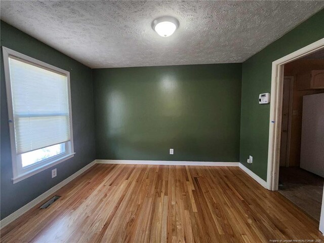 1519 Palmer Dr, Fayetteville, NC 28303 - unfurnished room with wood finished floors and a textured ceiling