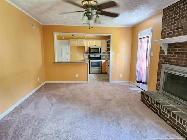 1519 Palmer Dr, Fayetteville, NC 28303 - unfurnished living room featuring ceiling fan, light colored carpet, a textured ceiling, and a brick fireplace