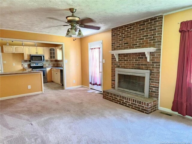1519 Palmer Dr, Fayetteville, NC 28303 - unfurnished living room featuring a ceiling fan, light carpet, a textured ceiling, and a brick fireplace