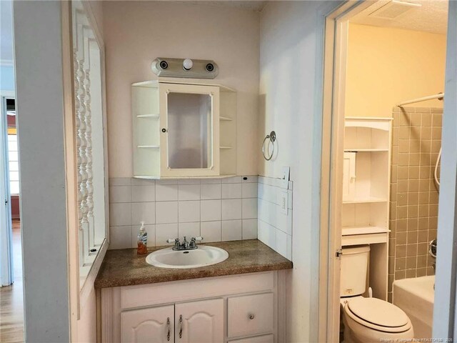 1519 Palmer Dr, Fayetteville, NC 28303 - bathroom with decorative backsplash, vanity, and shower / bath combination