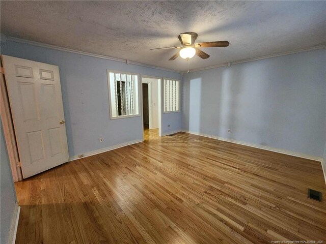 1519 Palmer Dr, Fayetteville, NC 28303 - spare room with crown molding, light wood-type flooring, ceiling fan, and a textured ceiling