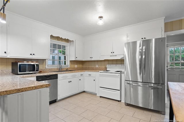 2613 N Edgewater Dr, Fayetteville, NC 28303 - kitchen featuring appliances with stainless steel finishes, under cabinet range hood, light countertops, white cabinetry, and crown molding