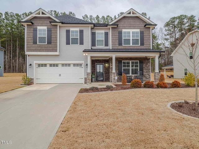 301 Porter Hill Dr, Youngsville, NC 27596 - craftsman inspired home with a porch, concrete driveway, a garage, and stone siding