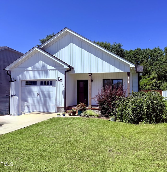 451 N Lincoln St, Benson, NC 27504 - view of front of home featuring an attached garage, a front lawn, and concrete driveway