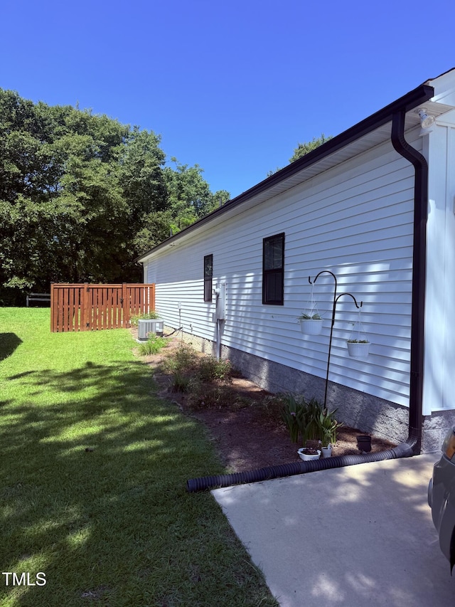 451 N Lincoln St, Benson, NC 27504 - view of property exterior featuring a cooling unit and a yard