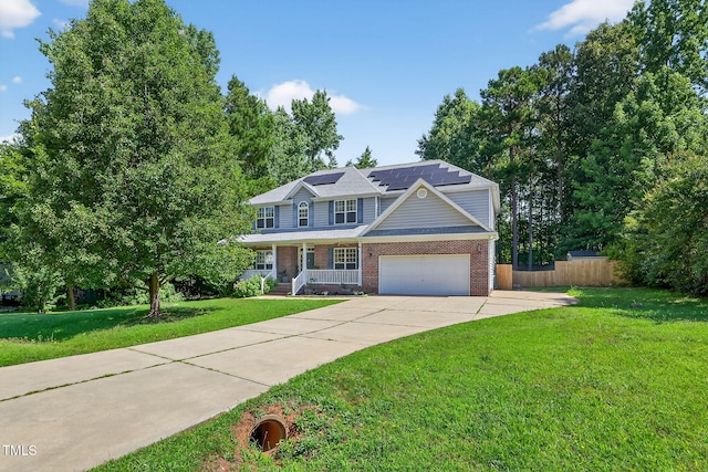 1205 Magnolia Hill Rd, Garner, NC 27529 - view of front of property with brick siding, covered porch, solar panels, a garage, and driveway