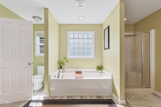 1205 Magnolia Hill Rd, Garner, NC 27529 - bathroom with a bath, a shower stall, and wood finished floors