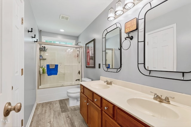 1205 Magnolia Hill Rd, Garner, NC 27529 - bathroom featuring wood finished floors, bath / shower combo with glass door, and double vanity