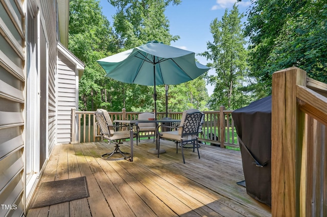 1205 Magnolia Hill Rd, Garner, NC 27529 - wooden terrace featuring outdoor dining area and view of wooded area