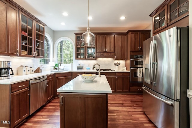 109 Fox Trap Ct, Garner, NC 27529 - kitchen with stainless steel appliances, dark wood-type flooring, decorative backsplash, light countertops, and recessed lighting