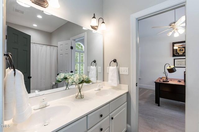 109 Fox Trap Ct, Garner, NC 27529 - bathroom with double vanity, a ceiling fan, a shower with curtain, and recessed lighting