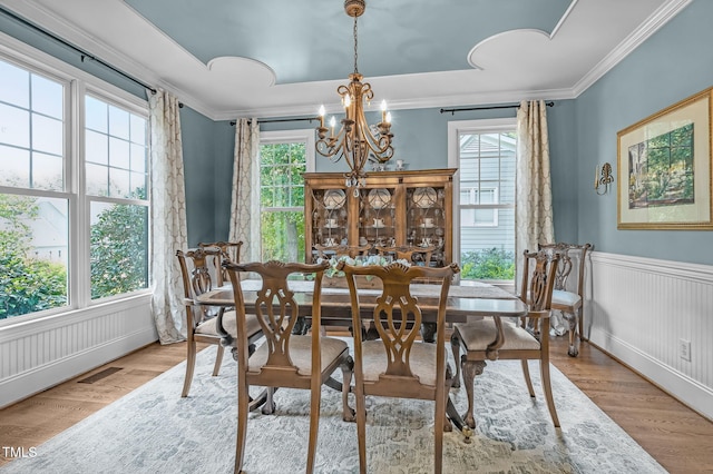 101 Tatum Ct, Holly Springs, NC 27540 - dining room featuring a chandelier, wood finished floors, ornamental molding, and wainscoting