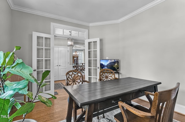 101 Tatum Ct, Holly Springs, NC 27540 - dining room with french doors, ornamental molding, wood finished floors, and a chandelier