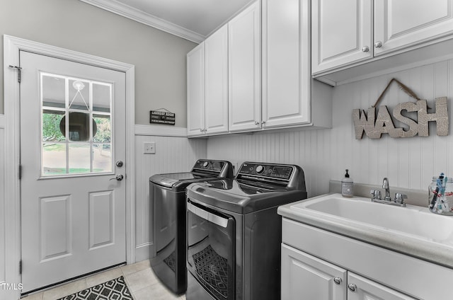 101 Tatum Ct, Holly Springs, NC 27540 - laundry room with cabinet space, washing machine and clothes dryer, light tile patterned flooring, and ornamental molding