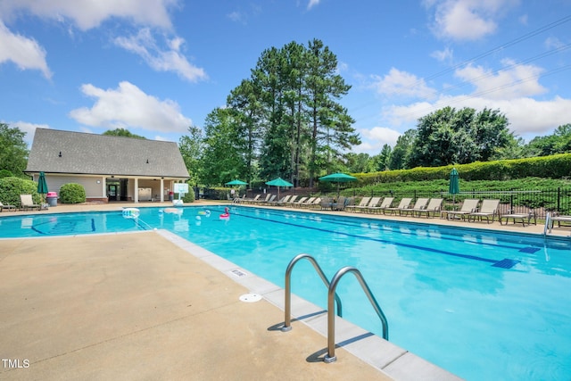 101 Tatum Ct, Holly Springs, NC 27540 - community pool with a patio area and view of wooded area