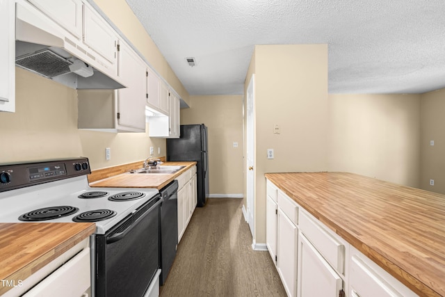 1320 Park Glen Dr Unit 204, Raleigh, NC 27610 - kitchen featuring black appliances, under cabinet range hood, butcher block counters, white cabinets, and a textured ceiling