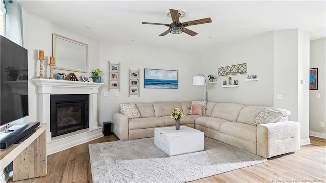 75 Bynum Ct, Carthage, NC 28327 - living area with a glass covered fireplace, wood finished floors, and ceiling fan