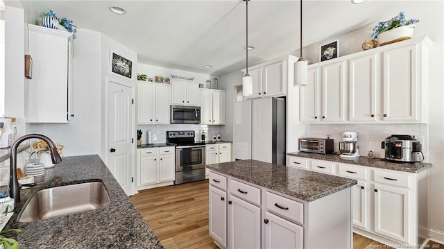 75 Bynum Ct, Carthage, NC 28327 - kitchen featuring appliances with stainless steel finishes, decorative backsplash, white cabinetry, light wood-type flooring, and recessed lighting