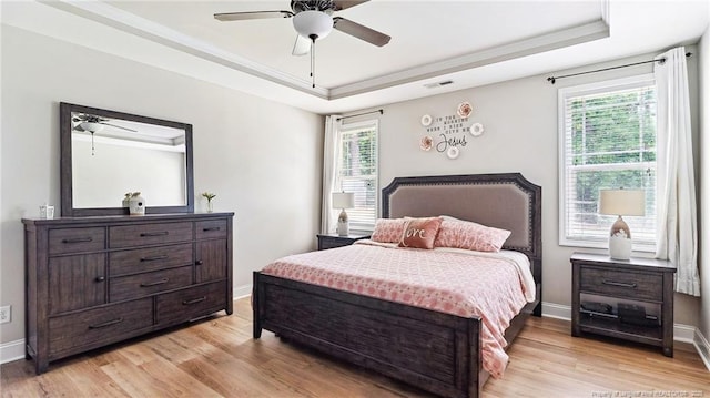 75 Bynum Ct, Carthage, NC 28327 - bedroom featuring a raised ceiling, multiple windows, light wood finished floors, and ornamental molding
