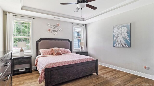 75 Bynum Ct, Carthage, NC 28327 - bedroom with a tray ceiling, multiple windows, light wood finished floors, and crown molding