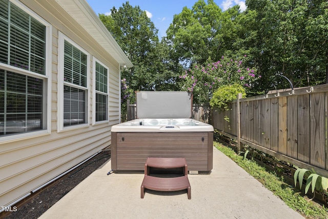 55 Kristopher Woods Dr, Youngsville, NC 27596 - fenced backyard with a hot tub and a patio area