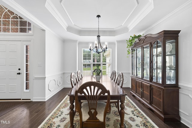 55 Kristopher Woods Dr, Youngsville, NC 27596 - dining area with a chandelier, dark wood finished floors, a wainscoted wall, a tray ceiling, and crown molding