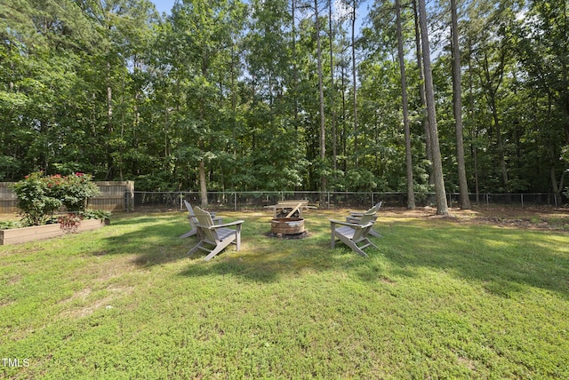 55 Kristopher Woods Dr, Youngsville, NC 27596 - fenced backyard with an outdoor fire pit