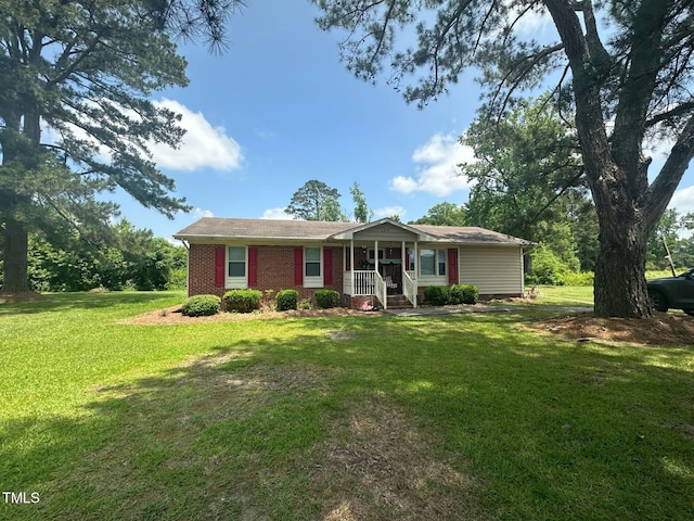 625 Revell Rd, Selma, NC 27576 - single story home with covered porch, a front lawn, and brick siding