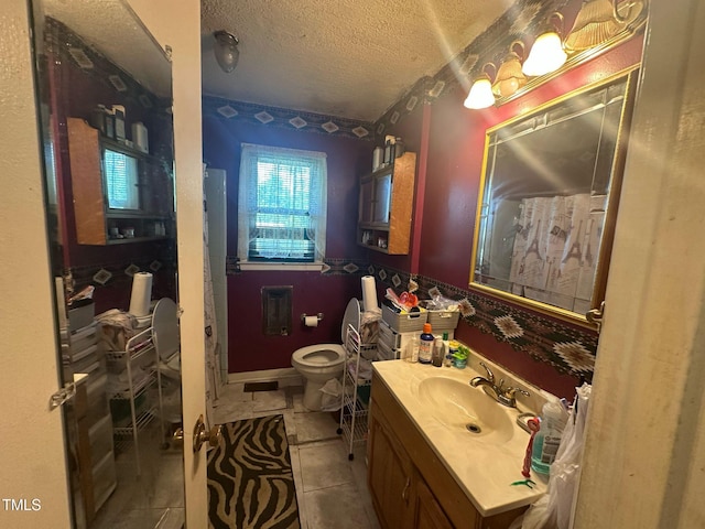 625 Revell Rd, Selma, NC 27576 - bathroom featuring a textured ceiling, vanity, and tile patterned flooring