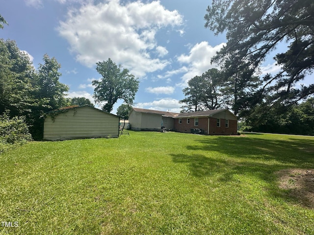 625 Revell Rd, Selma, NC 27576 - view of grassy yard with an outdoor structure