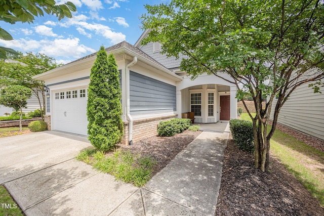 1204 E Rosedale Creek Dr, Durham, NC 27703 - view of property hidden behind natural elements featuring an attached garage and concrete driveway