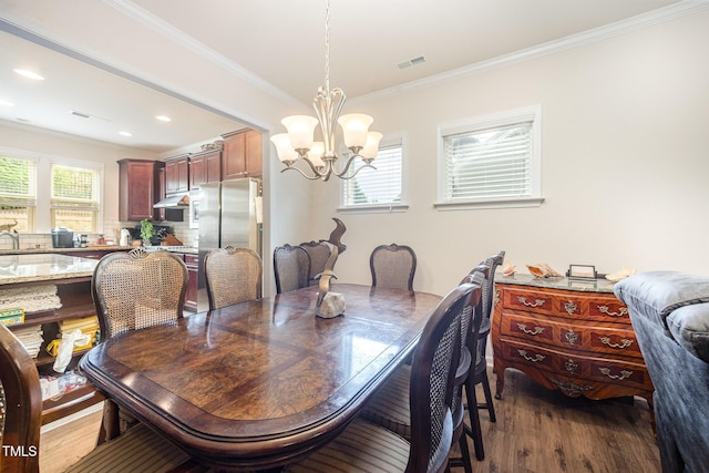 1204 E Rosedale Creek Dr, Durham, NC 27703 - dining space with a chandelier, wood finished floors, ornamental molding, and recessed lighting