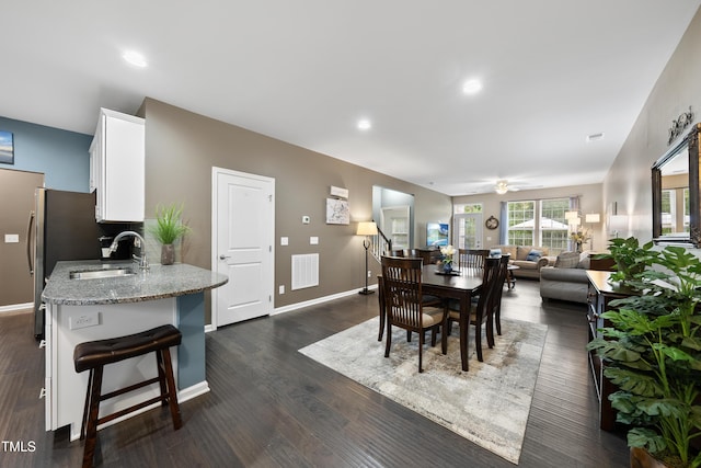 605 Smallwood Dr, Durham, NC 27703 - dining area with dark wood-style flooring, a ceiling fan, and recessed lighting
