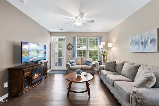 605 Smallwood Dr, Durham, NC 27703 - living area featuring a ceiling fan, dark wood-style flooring, and a glass covered fireplace
