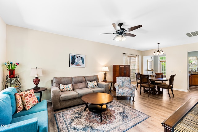 575 Tomkins Loop, Cary, NC 27519 - living room featuring a chandelier, light wood finished floors, and ceiling fan