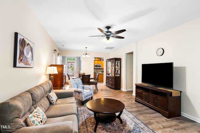 575 Tomkins Loop, Cary, NC 27519 - living room with wood finished floors, ceiling fan, and a chandelier
