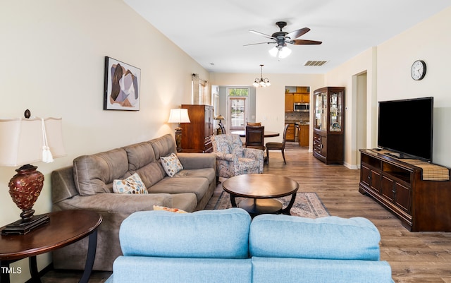 575 Tomkins Loop, Cary, NC 27519 - living room with wood finished floors, a ceiling fan, and a chandelier