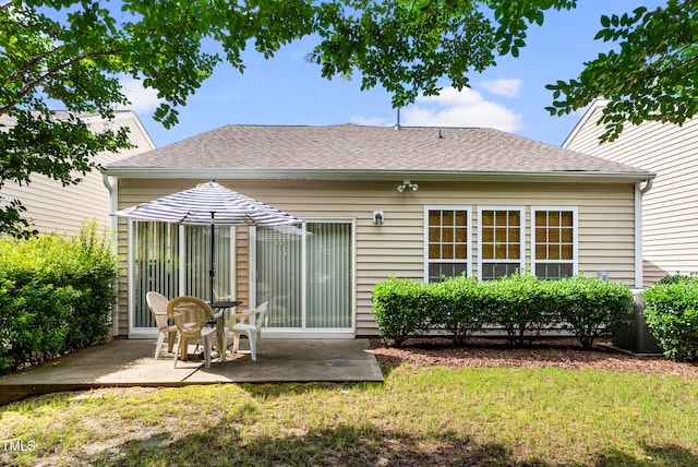 575 Tomkins Loop, Cary, NC 27519 - rear view of property with a patio, a lawn, and a shingled roof