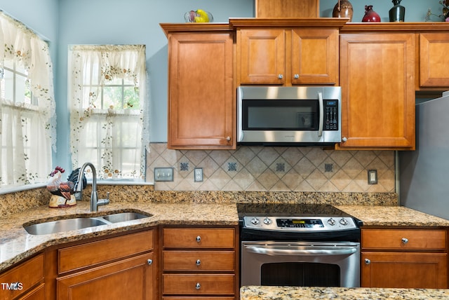 575 Tomkins Loop, Cary, NC 27519 - kitchen featuring appliances with stainless steel finishes, brown cabinets, and backsplash