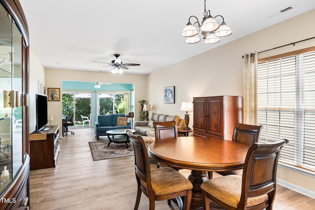575 Tomkins Loop, Cary, NC 27519 - dining room featuring ceiling fan, light wood-style floors, and a chandelier