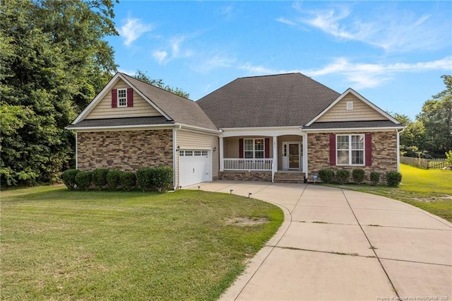 4817 Kiara Dr, Hope Mills, NC 28348 - view of front of property with covered porch, stone siding, driveway, a garage, and a front yard