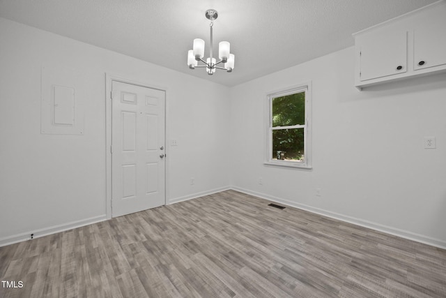 37 Weeping Willow Ln, Lillington, NC 27546 - empty room featuring a chandelier, wood finished floors, and electric panel