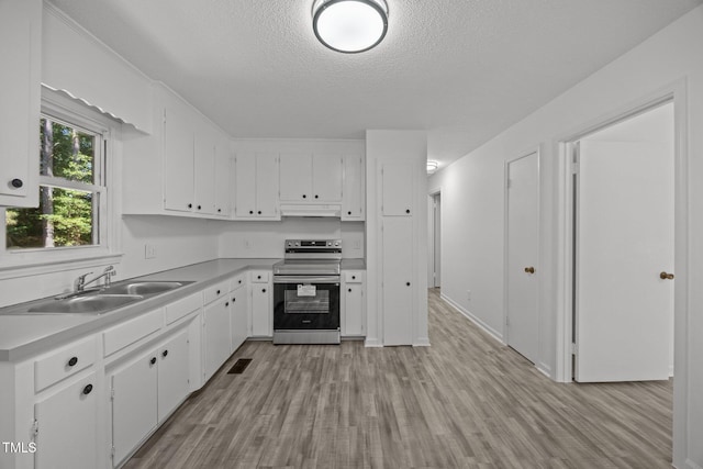 37 Weeping Willow Ln, Lillington, NC 27546 - kitchen featuring stainless steel range with electric stovetop, light wood-style flooring, under cabinet range hood, white cabinets, and a textured ceiling