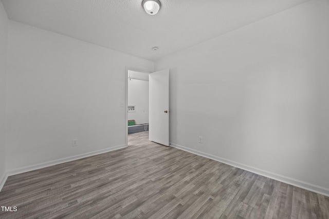 37 Weeping Willow Ln, Lillington, NC 27546 - empty room featuring wood finished floors and baseboards