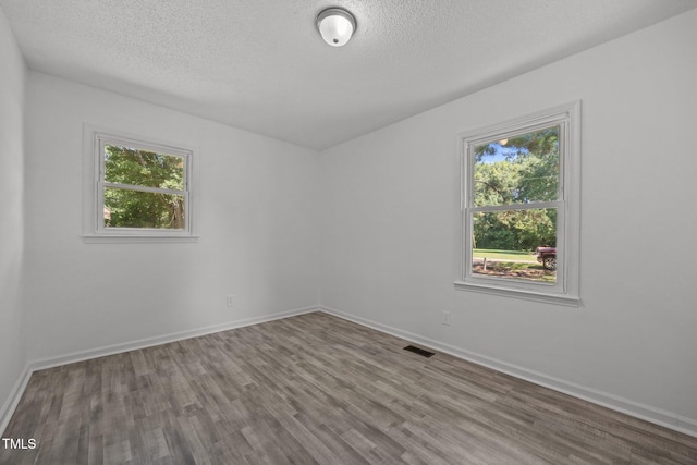 37 Weeping Willow Ln, Lillington, NC 27546 - empty room with wood finished floors and a textured ceiling