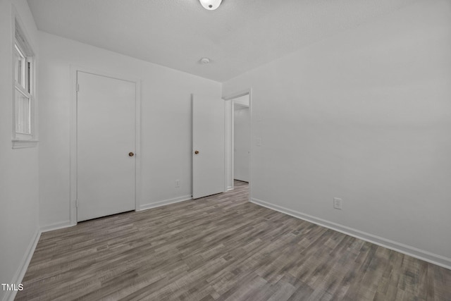 37 Weeping Willow Ln, Lillington, NC 27546 - unfurnished bedroom with wood finished floors and a closet